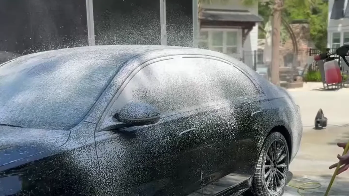 Snow foam application on a luxury sedan driveway detail in Charlotte NC